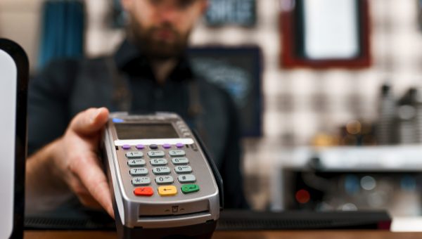 Cashier gives the client a payment terminal