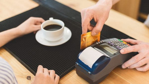 Quick and easy payments. Close up of transaction with credit card in cafe for coffee