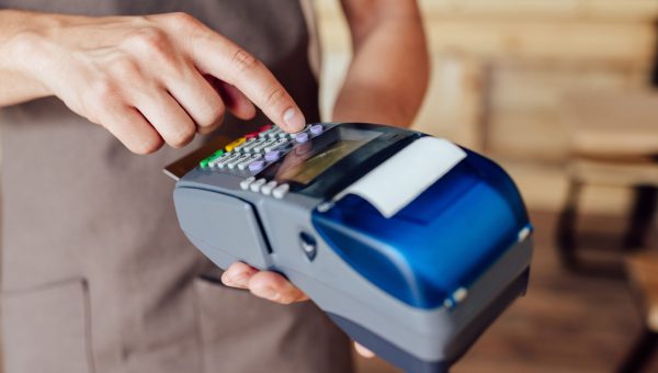 cropped shot of waiter receiving payment with credit card and terminal