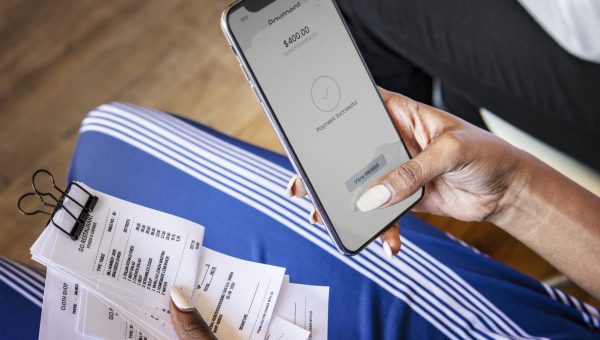 Woman paying bills online via internet banking